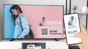 denim clothing ad on TV with qr code scanned by phone